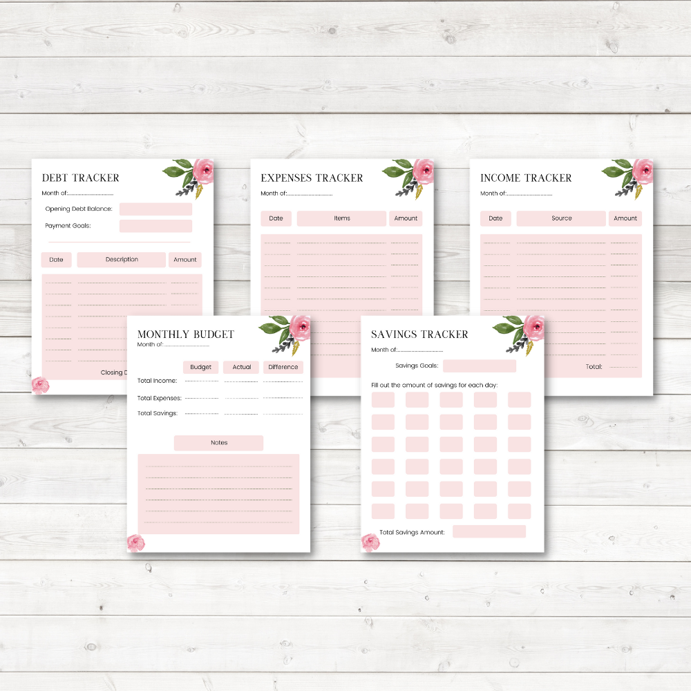 pink budget planner sheets on white wood background