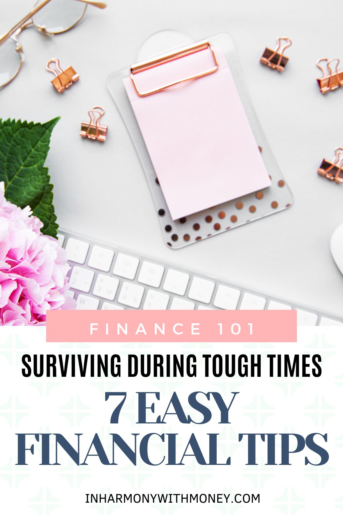 desk with pink clipboard, rose gold binder clips, glasses, pink flowers and a computer keyboard with text surviving during tough times, 7 easy financial tips